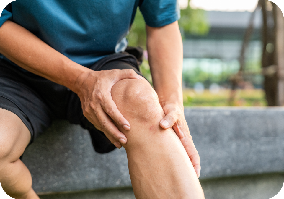 Person holding knee outdoors, focusing on bone and joint health, supplements health