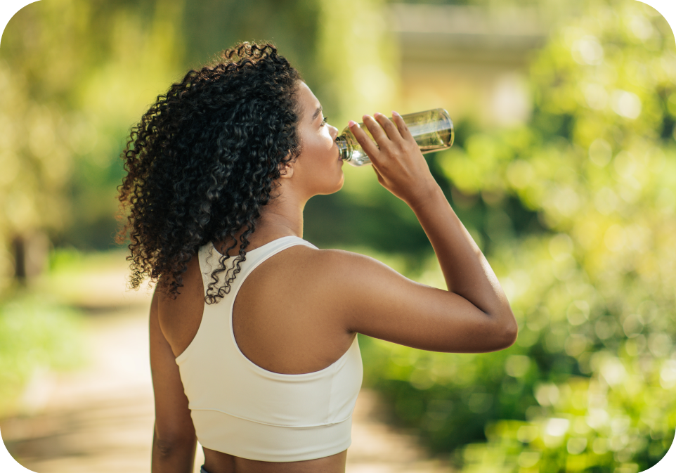 Woman drinking water outdoors, supplements health and hydration wellness