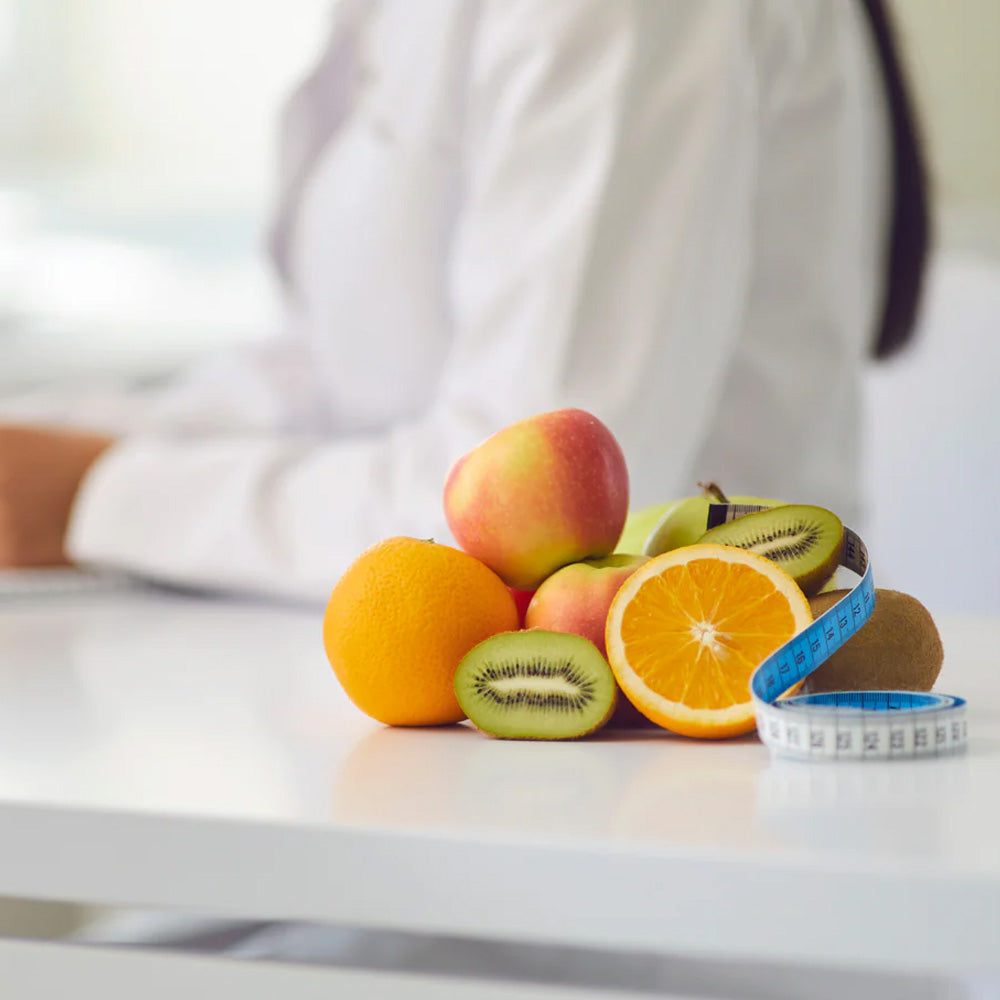 supplements health concept with fruits, measuring tape, and nutritionist in white coat