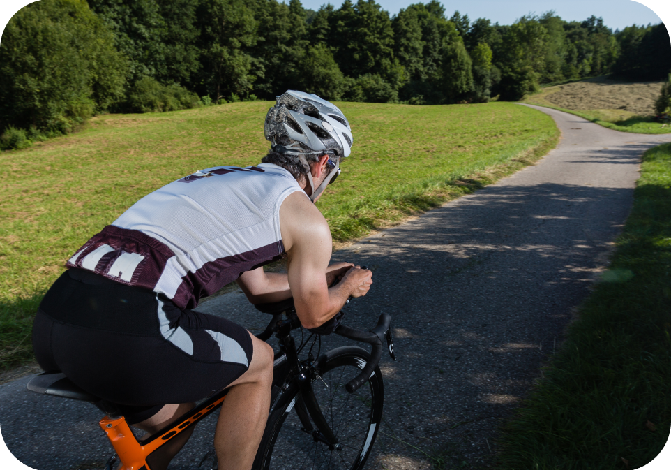 Cyclist riding on country road, supplements health, outdoor fitness activity
