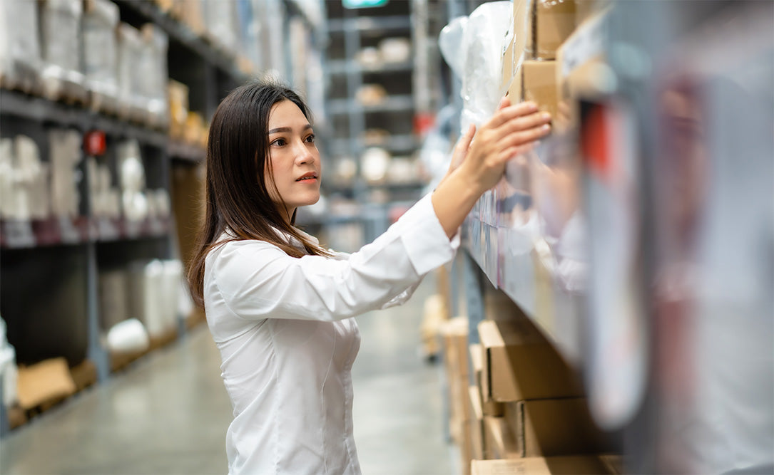 Worker handling boxes in warehouse, supplements health distribution concept