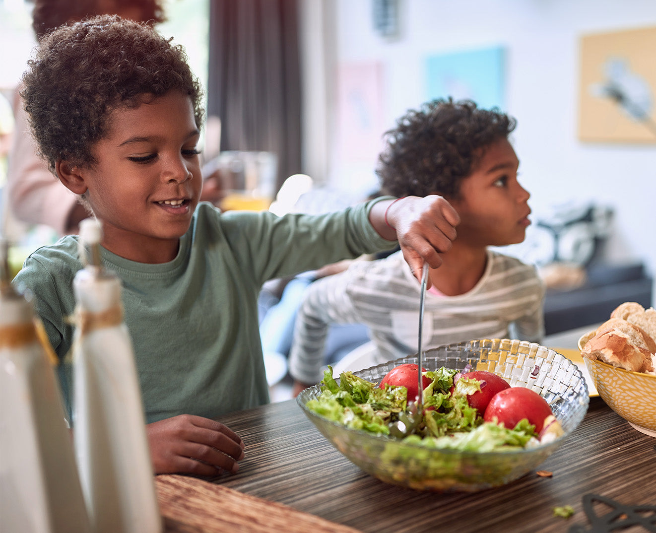 Children enjoying fresh salad at home, supplements health concept